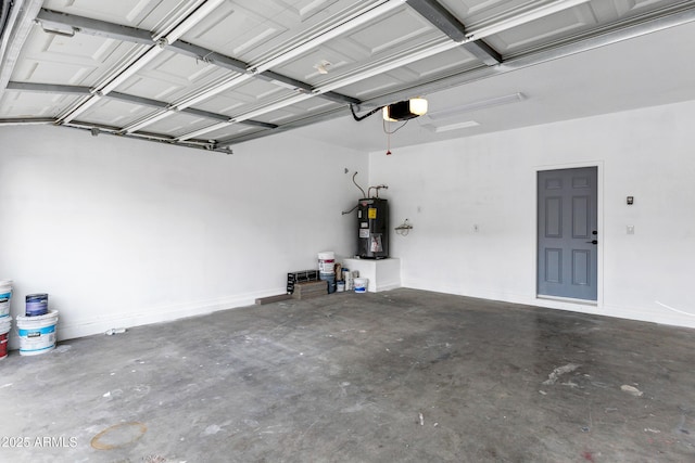 garage with a garage door opener and electric water heater