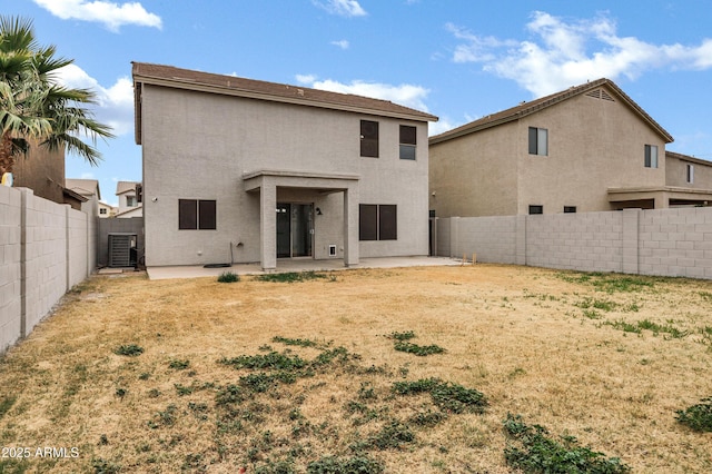 back of property with cooling unit and a patio area