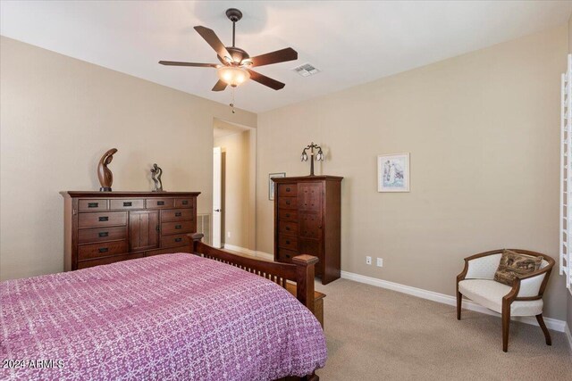 bedroom featuring light carpet and ceiling fan