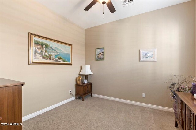 unfurnished room with light carpet, vaulted ceiling, and ceiling fan