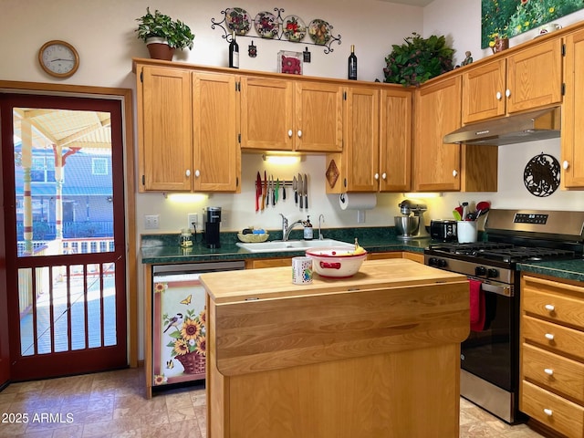 510 Tombstone Cyn, Bisbee, AZ 85603 - kitchen featuring stainless steel range with gas cooktop, under cabinet range hood, a sink, a center island, and wood counters
