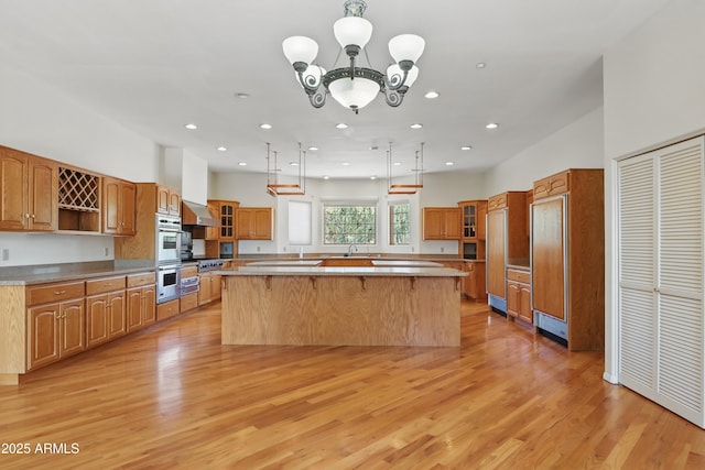 889 E Dealers Choice Ln, Payson, AZ 85541 - kitchen with a center island, open shelves, light wood finished floors, and glass insert cabinets