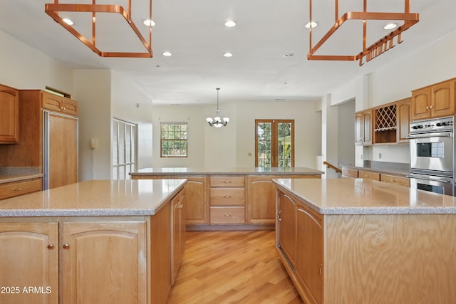 889 E Dealers Choice Ln, Payson, AZ 85541 - kitchen featuring light wood-style floors, a center island, double oven, and a notable chandelier
