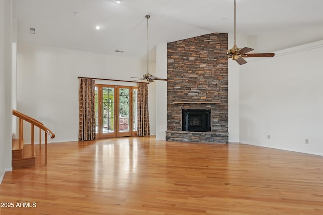 889 E Dealers Choice Ln, Payson, AZ 85541 - unfurnished living room with light wood-type flooring, a ceiling fan, a stone fireplace, and high vaulted ceiling