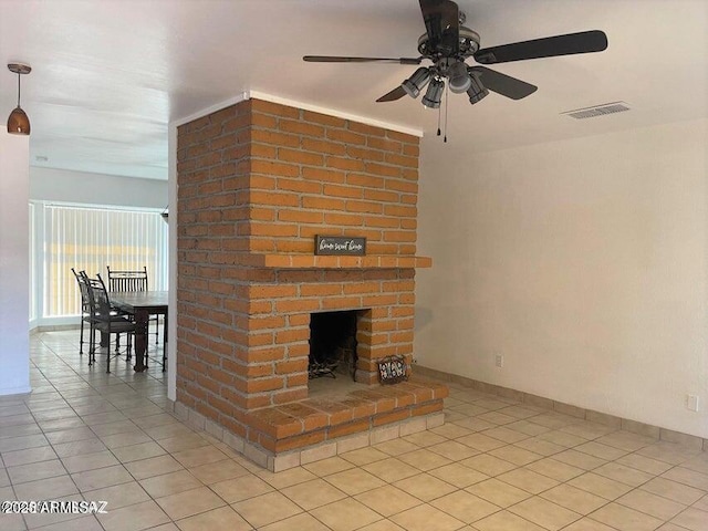 unfurnished living room featuring light tile patterned floors, a brick fireplace, and ceiling fan