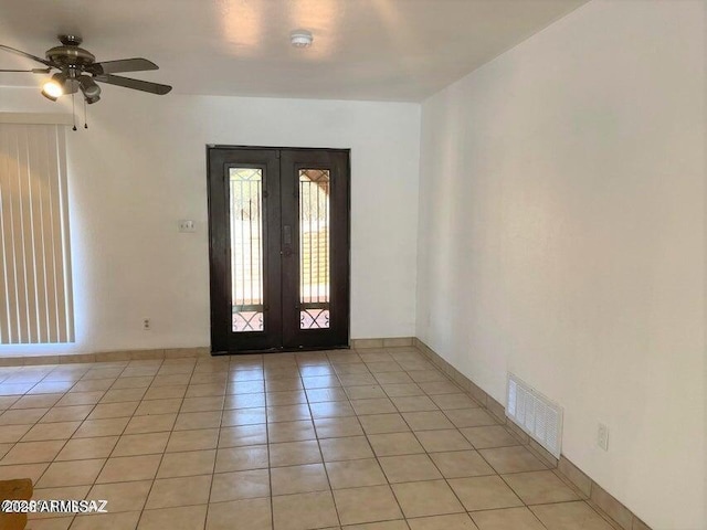 entryway with ceiling fan, light tile patterned floors, and french doors