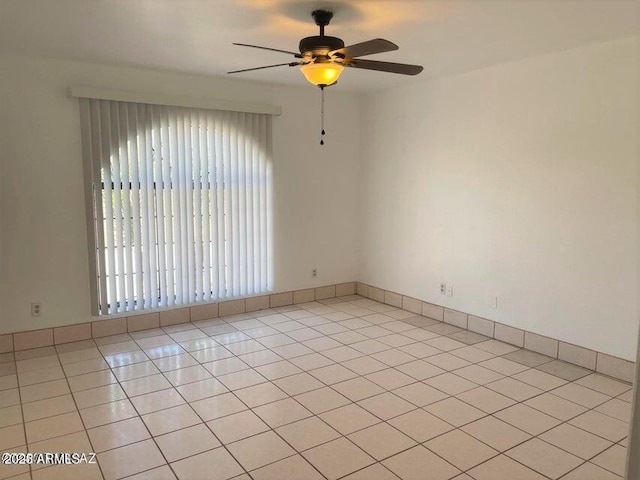 unfurnished room with light tile patterned floors and ceiling fan