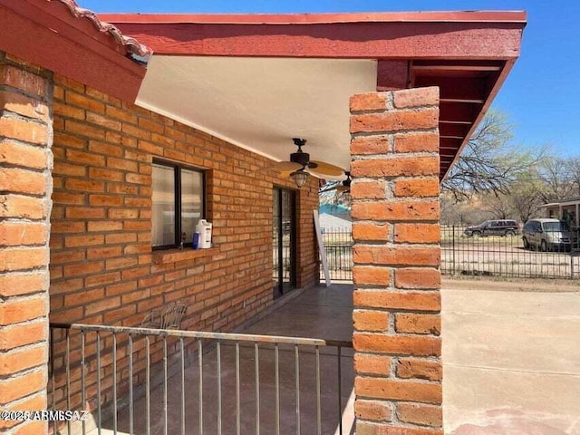 view of side of home with ceiling fan