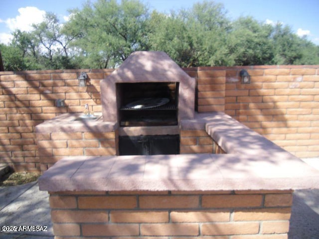 view of patio / terrace featuring an outdoor fireplace