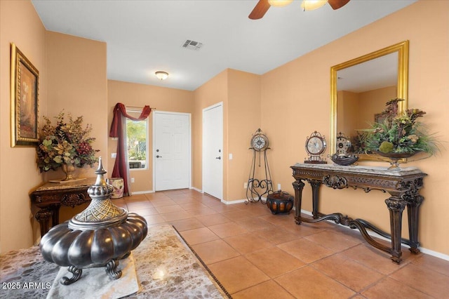 foyer featuring ceiling fan and light tile patterned floors