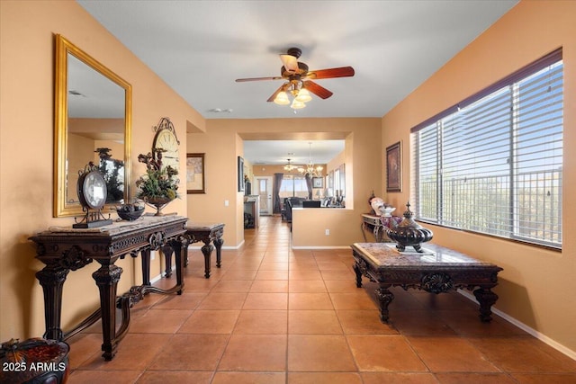 corridor featuring a chandelier, a wealth of natural light, and light tile patterned flooring