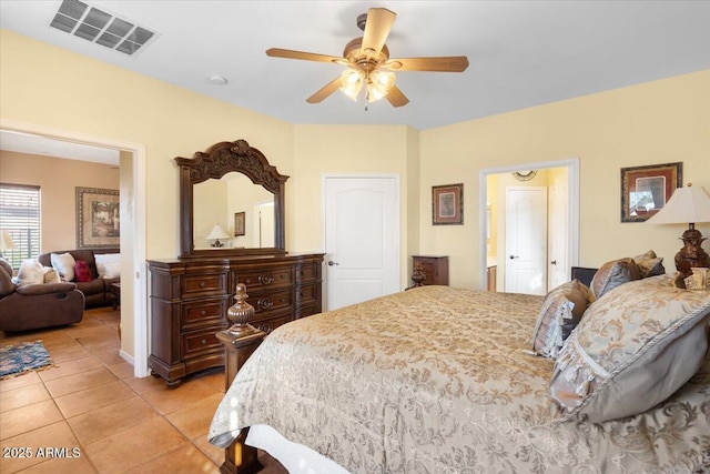 bedroom featuring ceiling fan, light tile patterned floors, and ensuite bathroom