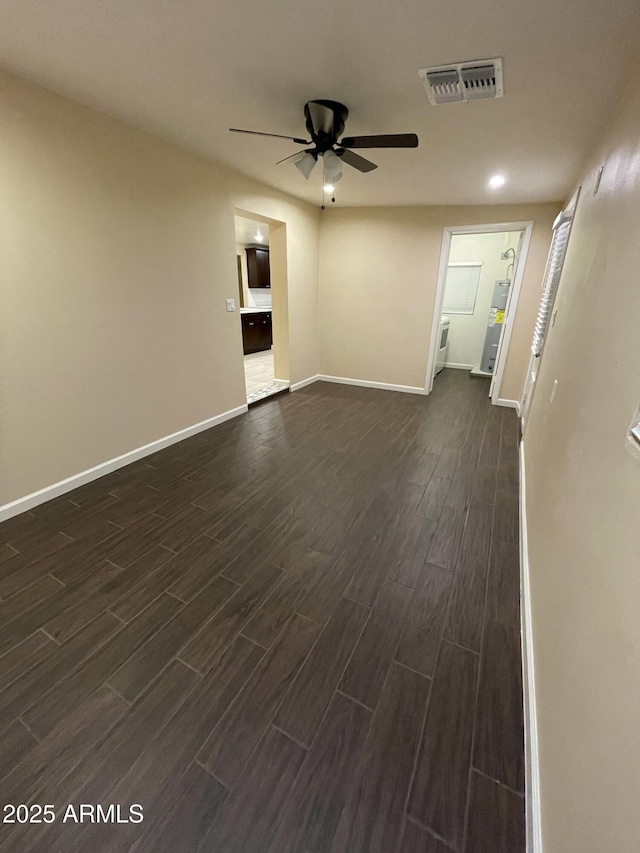 unfurnished room featuring ceiling fan and dark hardwood / wood-style floors