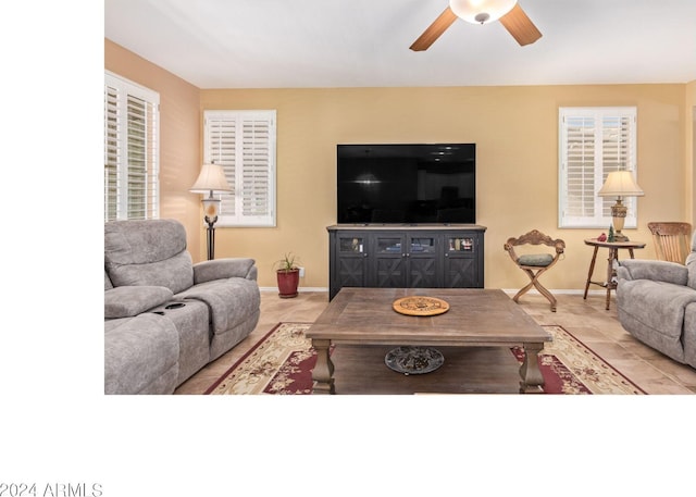 tiled living room with ceiling fan