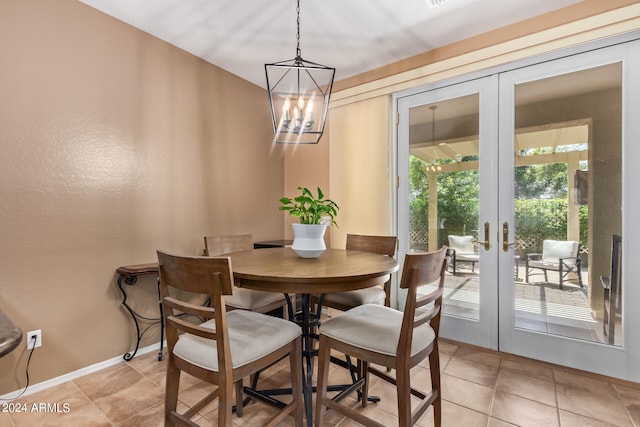 dining area with an inviting chandelier, light tile patterned floors, and french doors