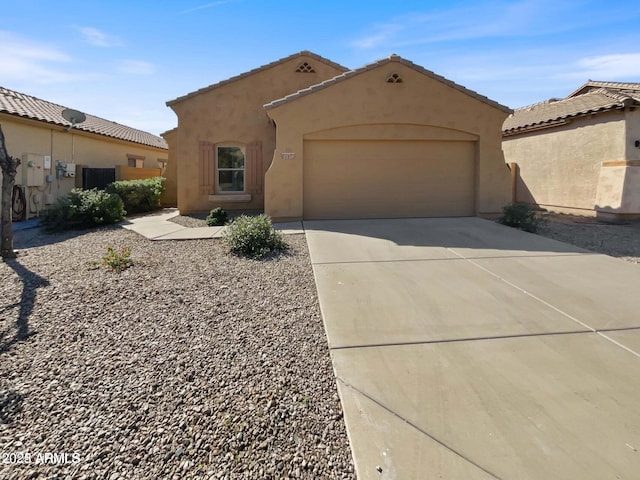 5339 W Maldonado Rd, Laveen, AZ 85339 - mediterranean / spanish home with stucco siding, a garage, driveway, and a tile roof
