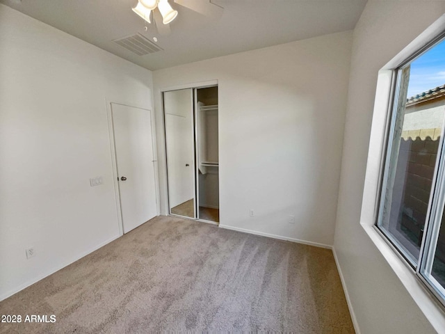 5339 W Maldonado Rd, Laveen, AZ 85339 - unfurnished bedroom with carpet, a closet, baseboards, and a ceiling fan