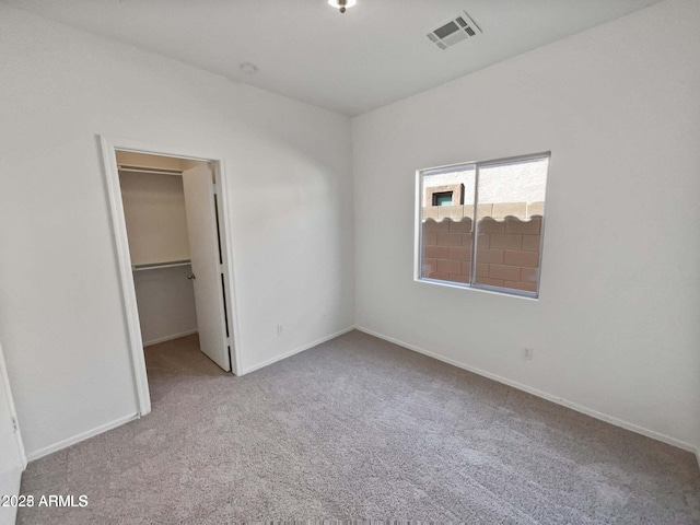 5339 W Maldonado Rd, Laveen, AZ 85339 - unfurnished bedroom featuring carpet floors, a walk in closet, baseboards, and a closet