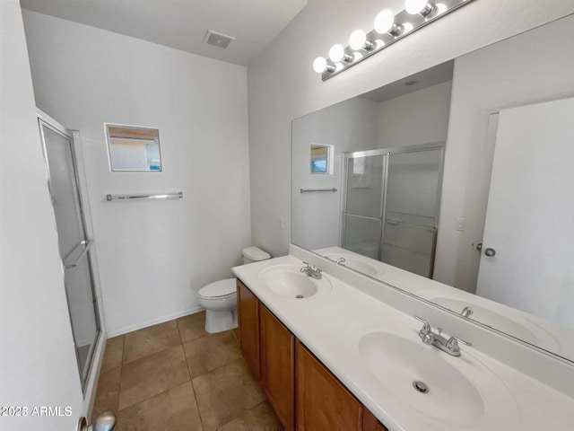 5339 W Maldonado Rd, Laveen, AZ 85339 - full bathroom with a shower stall, double vanity, toilet, and tile patterned flooring