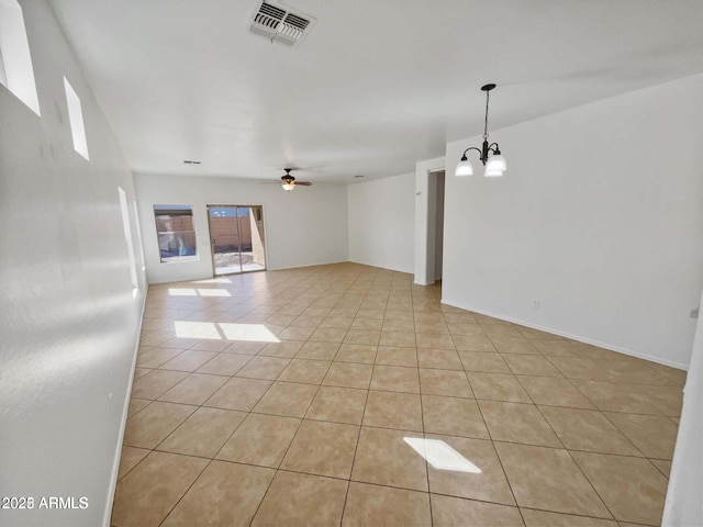 5339 W Maldonado Rd, Laveen, AZ 85339 - empty room featuring light tile patterned flooring, a chandelier, and a ceiling fan