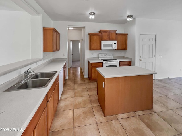 5339 W Maldonado Rd, Laveen, AZ 85339 - kitchen with white appliances, a sink, brown cabinetry, a kitchen island, and light tile patterned floors