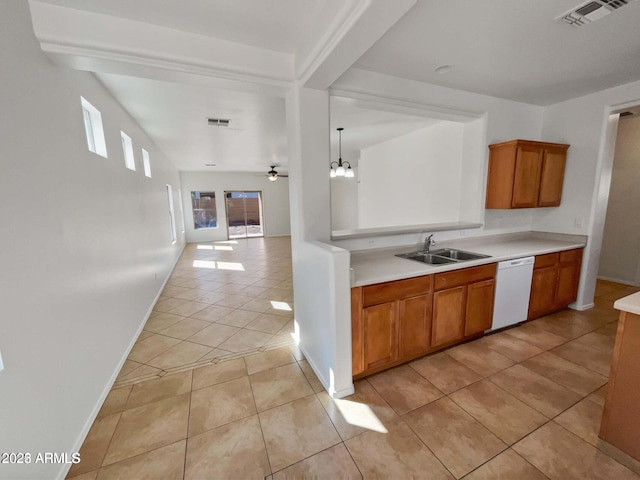 5339 W Maldonado Rd, Laveen, AZ 85339 - kitchen featuring dishwasher, a sink, light tile patterned floors, light countertops, and brown cabinetry