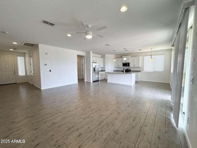 30507 N 167th St, Scottsdale, AZ 85262 - unfurnished living room with wood finished floors, ceiling fan, baseboards, and recessed lighting