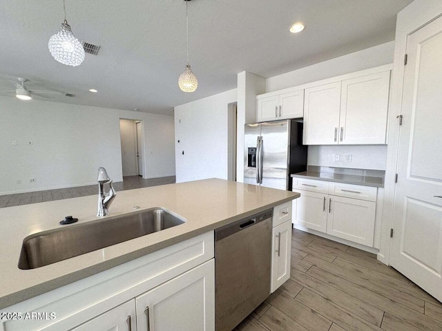 30507 N 167th St, Scottsdale, AZ 85262 - kitchen featuring stainless steel appliances, a sink, decorative light fixtures, white cabinets, and recessed lighting