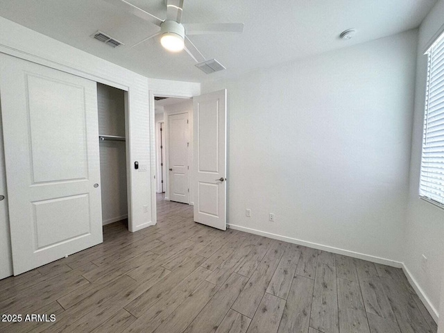 30507 N 167th St, Scottsdale, AZ 85262 - unfurnished bedroom with light wood-style flooring, baseboards, a closet, and multiple windows