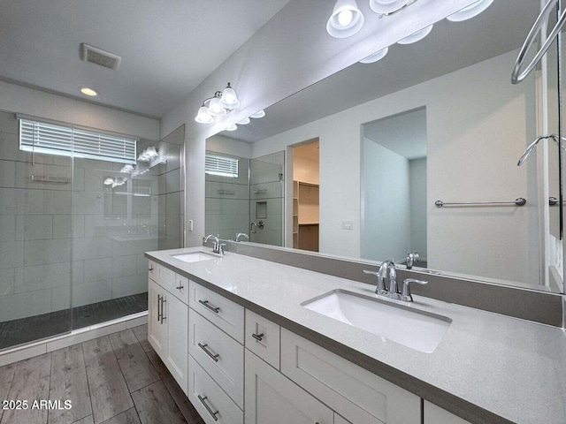 30507 N 167th St, Scottsdale, AZ 85262 - full bathroom featuring tiled shower, double vanity, a walk in closet, wood finished floors, and recessed lighting