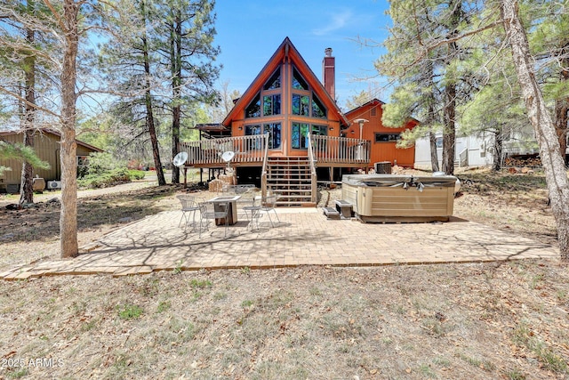 17425 Sequoia Dr, Munds Park, AZ 86017 - rear view of property with a hot tub, a deck, a patio area, a chimney, and stairs