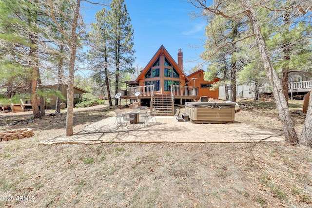 17425 Sequoia Dr, Munds Park, AZ 86017 - back of property with a hot tub, a deck, a patio, and a chimney