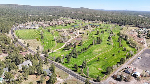 17425 Sequoia Dr, Munds Park, AZ 86017 - aerial view of property and surrounding area with a forest, a mountainous background, and a golf club