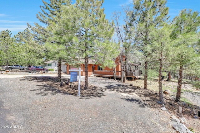17425 Sequoia Dr, Munds Park, AZ 86017 - view of front of home featuring a wooden deck, driveway, and an attached garage