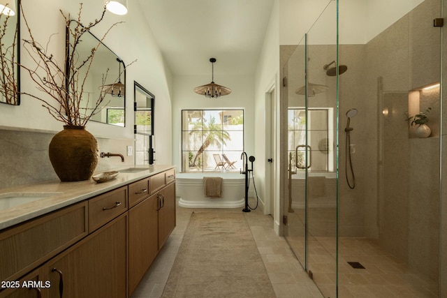 8910 E Topeka Dr, Scottsdale, AZ 85255 - full bathroom with a stall shower, a freestanding tub, double vanity, and tile patterned flooring