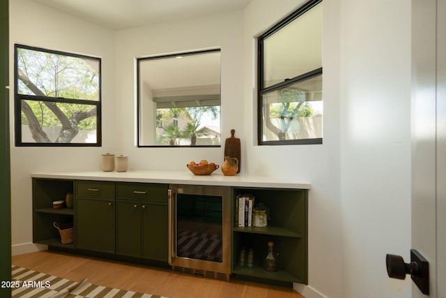 8910 E Topeka Dr, Scottsdale, AZ 85255 - indoor dry bar featuring wine cooler, light wood-style floors, and baseboards