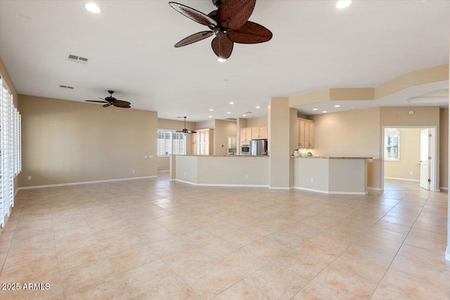 unfurnished living room featuring ceiling fan and light tile patterned floors