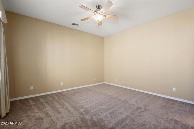 spare room featuring ceiling fan and carpet flooring