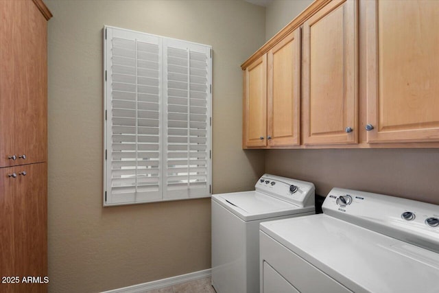 laundry room featuring cabinets and washing machine and clothes dryer