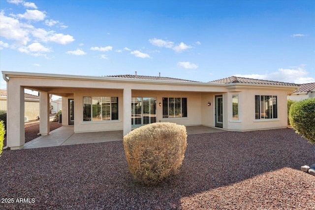 back of house with a patio