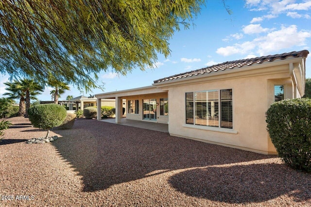 back of house with a patio