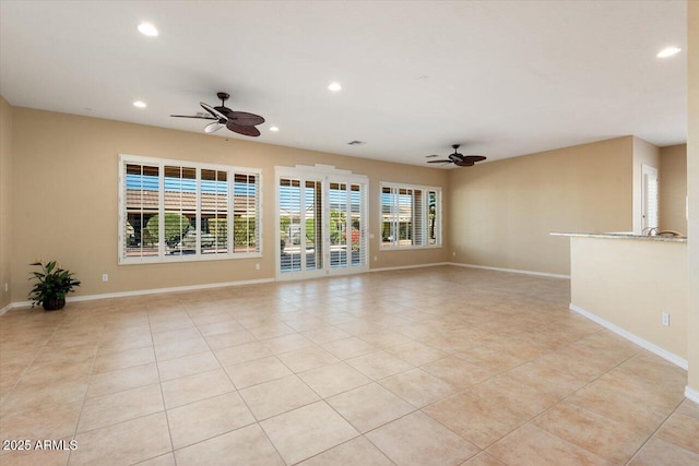 unfurnished living room with ceiling fan and light tile patterned floors