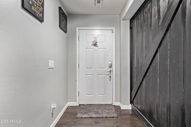 entryway with dark hardwood / wood-style floors