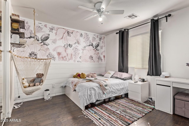 bedroom with dark hardwood / wood-style flooring and ceiling fan