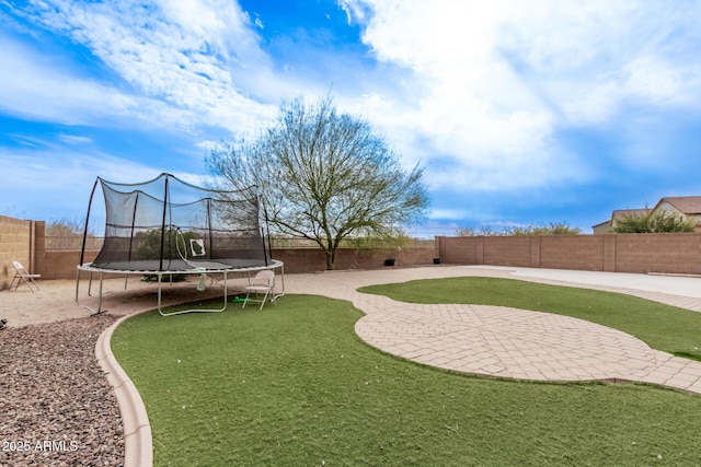 view of yard featuring a patio area and a trampoline