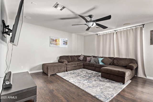 living room featuring dark hardwood / wood-style flooring and ceiling fan