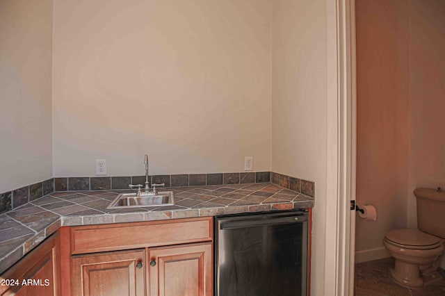bathroom with toilet and a sink