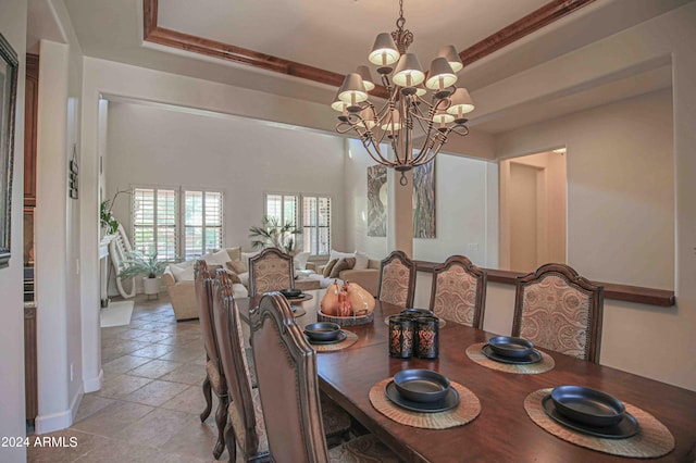 dining space featuring a tray ceiling and an inviting chandelier