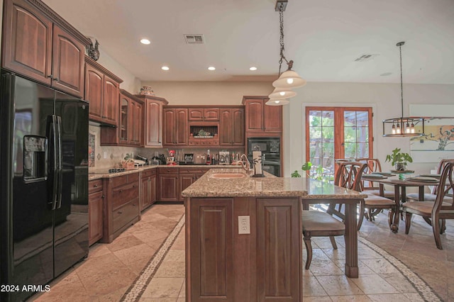 kitchen featuring recessed lighting, visible vents, black appliances, and a sink