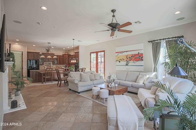 living room with a ceiling fan, recessed lighting, stone tile floors, and visible vents